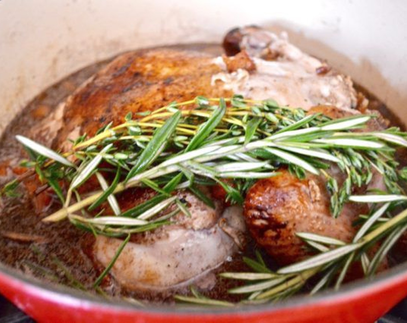 step 9 Pour in the reserved wine from the marinade and put the chicken, bacon, herbs, and spice sachet back into the pot. Bring it to a boil, then cover the pot and reduce it to a simmer. Let the coq au vin cook for 2 hours.