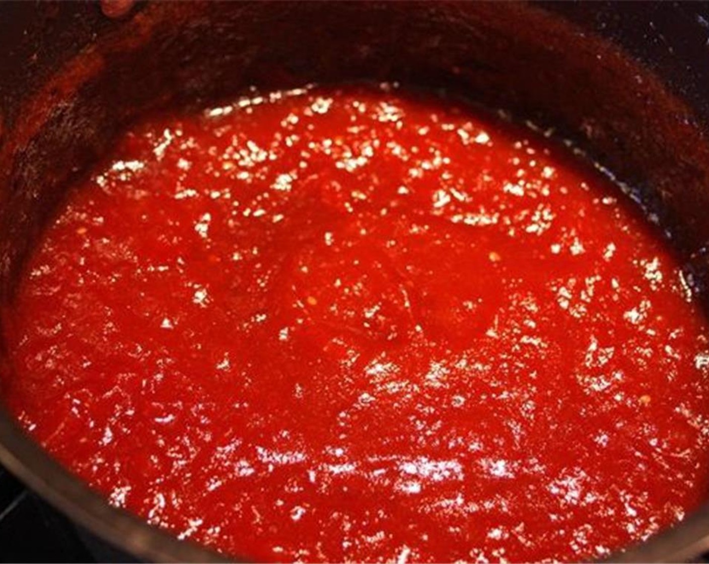 step 8 Cook for 1.5 to 2 hours until the jam starts to thicken. Remove the cinnamon stick and use an immersion blender to break up any remaining chunks of tomatoes to create a smoother consistency.