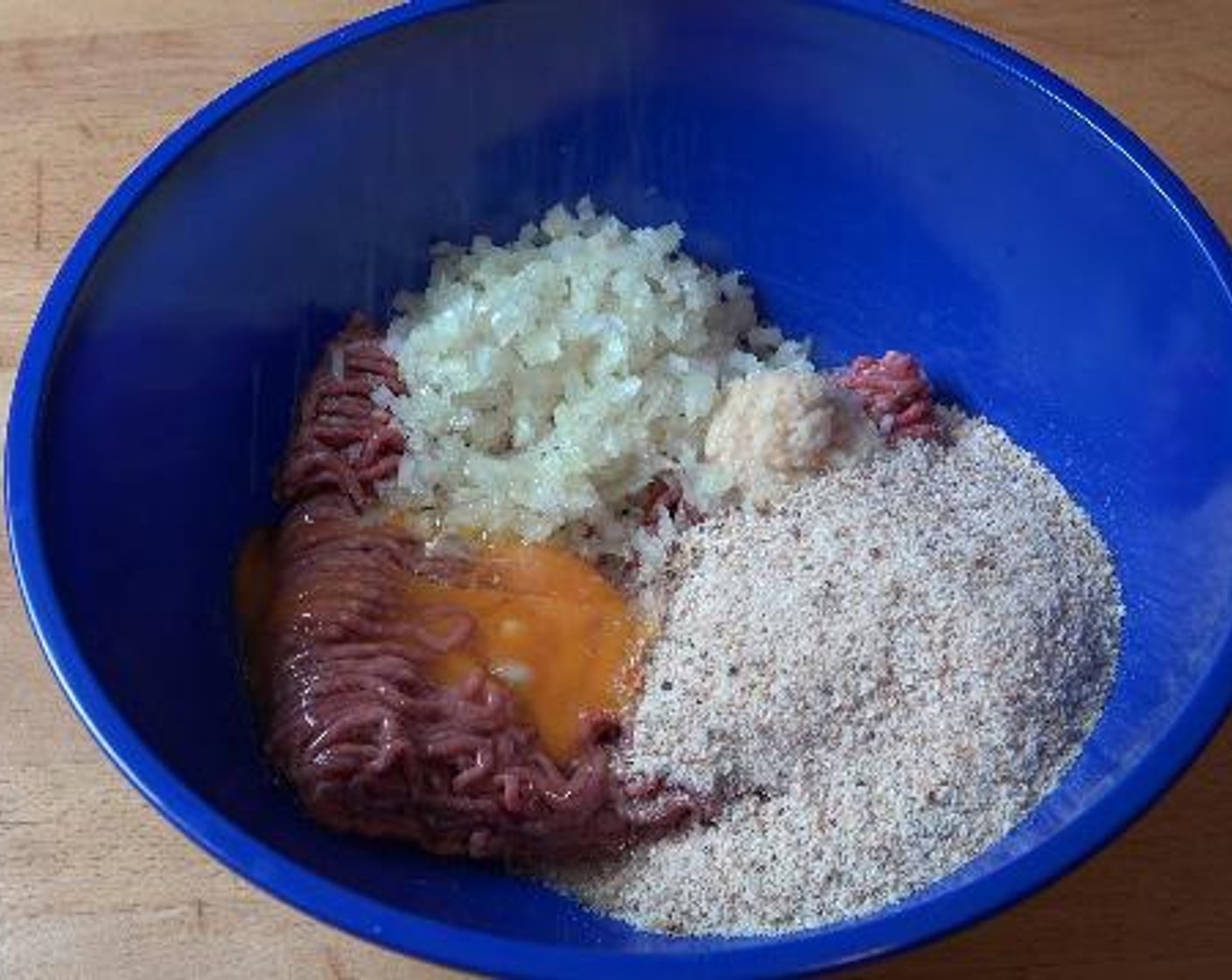 step 1 Inside a big bowl, add the Ground Beef (1.1 lb), Onion (1/2), Garlic (1 clove), Breadcrumbs (1/2 cup), Eggland's Best Classic Egg (1), Salt (to taste), and Ground Black Pepper (to taste). Using your hands mix everything together until it is nicely combined.