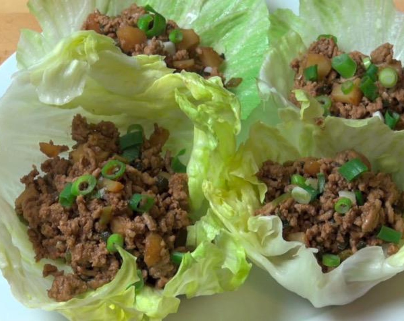 step 4 Spoon the mixture into cups made of Iceberg Lettuce (1 head). Garnish with additional Scallions (to taste). Serve and enjoy!