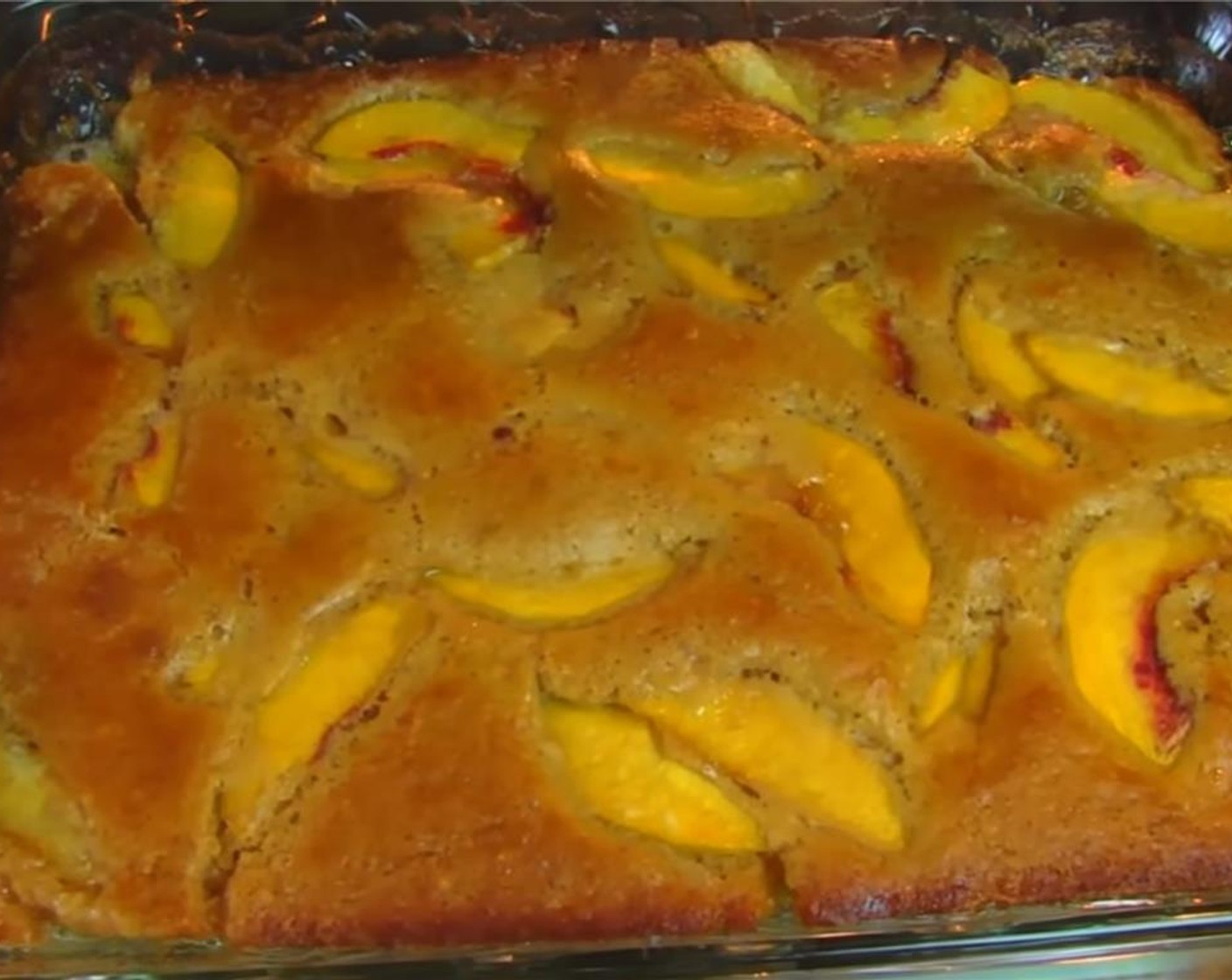 step 7 Bake for about 25 to 30 minutes, or until the batter has risen around the peaches, the top is light brown, and the sides are darker brown.