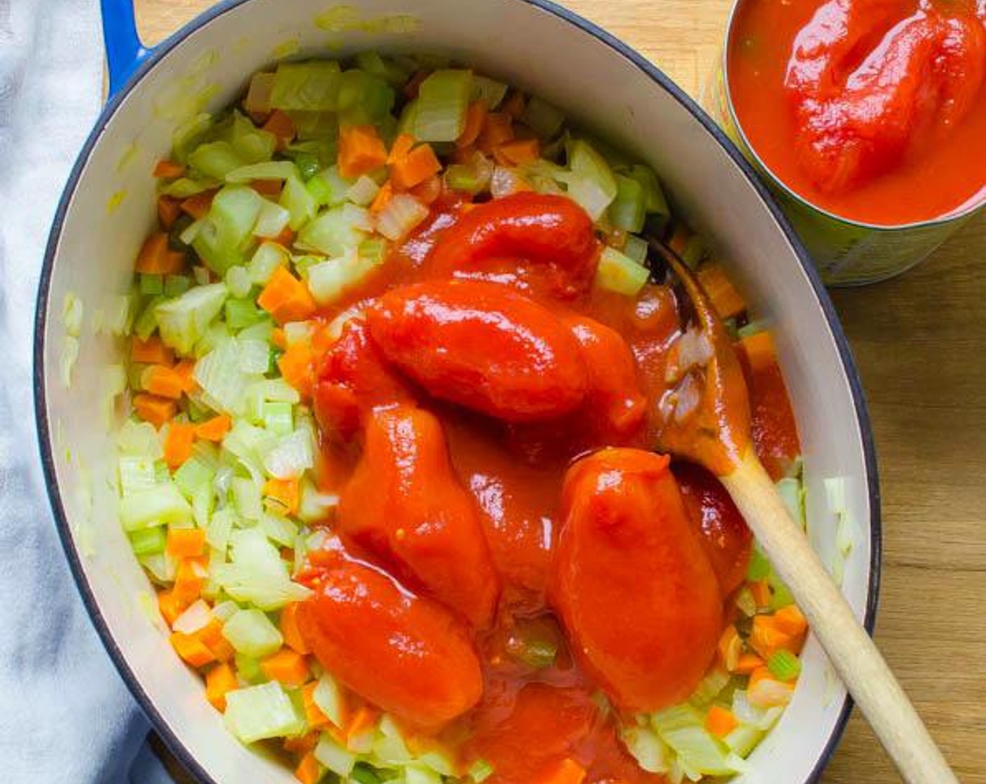 step 3 With clean hands, remove tomatoes one at a time from the Whole Peeled Tomatoes (3 cans) and squeeze them over the pot to release their juices and squish them. Add them to the pot along with the remaining tomato puree and stir.