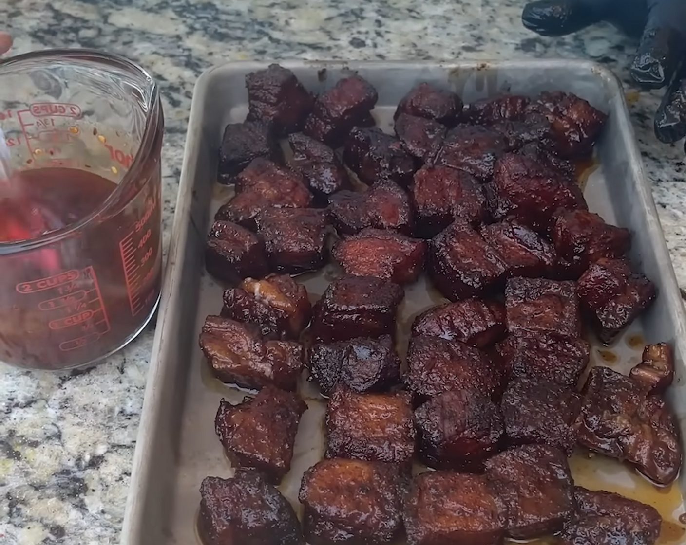 step 7 After an hour, remove the pan from the grill, carefully remove each pork belly burnt end from the hot liquid in the pan and transfer it to a small baking pan.