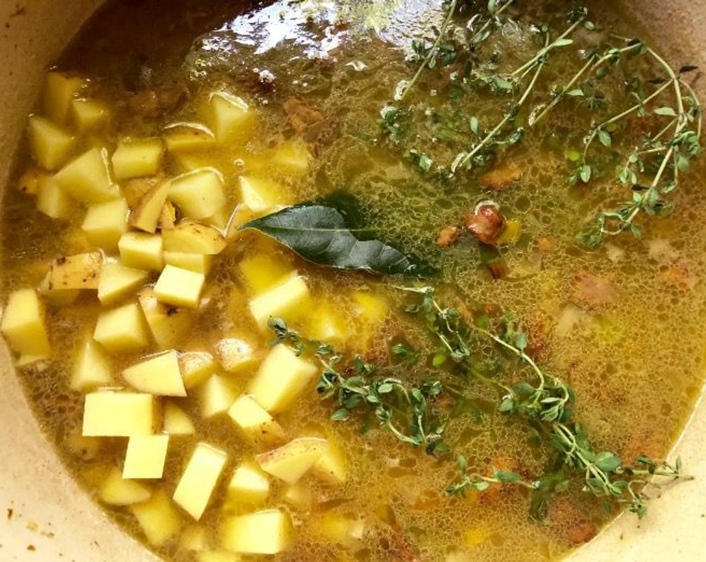 step 8 Add the Yukon Gold Potato (1), Fresh Thyme (3 sprigs), and Bay Leaf (1). Bring to a simmer and cook until the potatoes are tender, about 15 minutes.