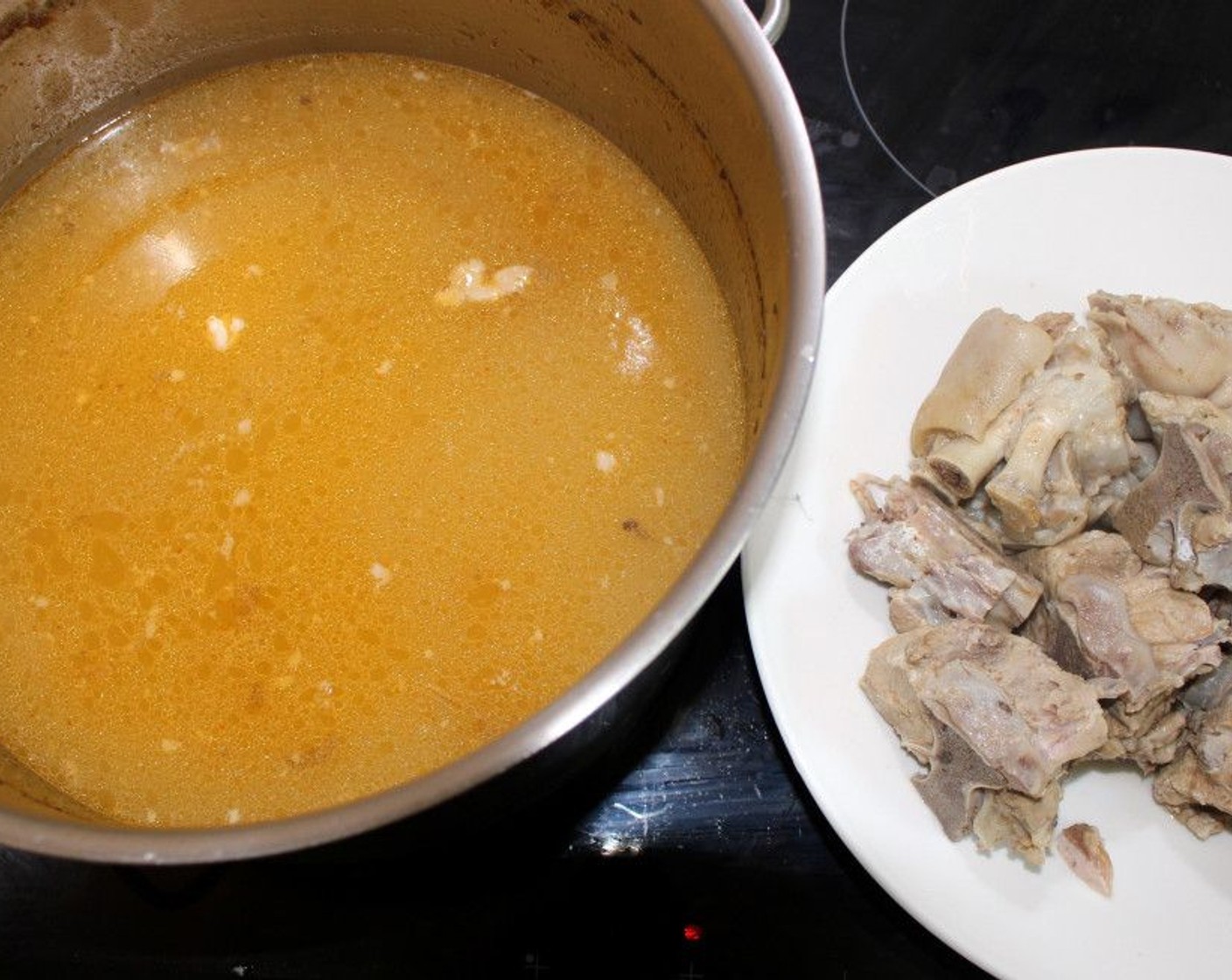 step 2 Remove the feet from the stock, and cut the meat into bite-size pieces. There should be about 2-quarts of stock at this point.