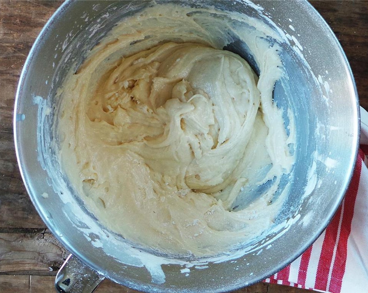 step 5 Alternate between adding the flour and Buttermilk (1/2 cup), adding the flour THREE times and the buttermilk TWICE (start and end with the flour). Add the flour to parchment paper for an easy pour!