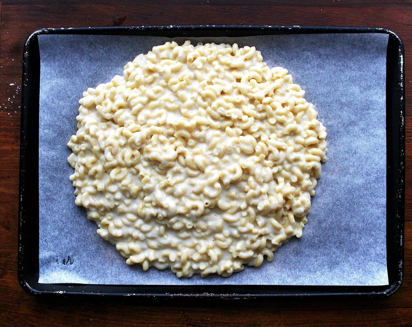 step 8 Line a jelly roll pan with a sheet of parchment paper. Spread macaroni mixture over top.