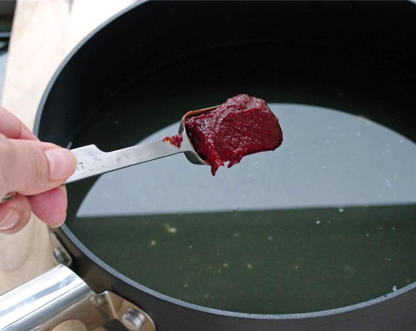 step 10 Pour the reserved stock in a non stick pan. Add Gochujang (1/3 cup) to the pan.