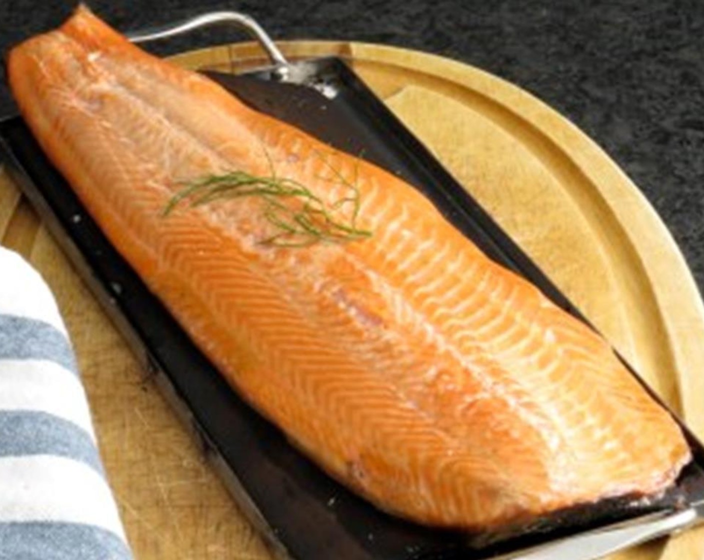 step 5 Place Atlantic Salmon Fillet (1.5 lb) skin side down on the plank. Close the lid and cook for 10-12 minutes for medium. Monitor the heat so that the plank is constantly emitting a steady stream of smoke, not too heavy.