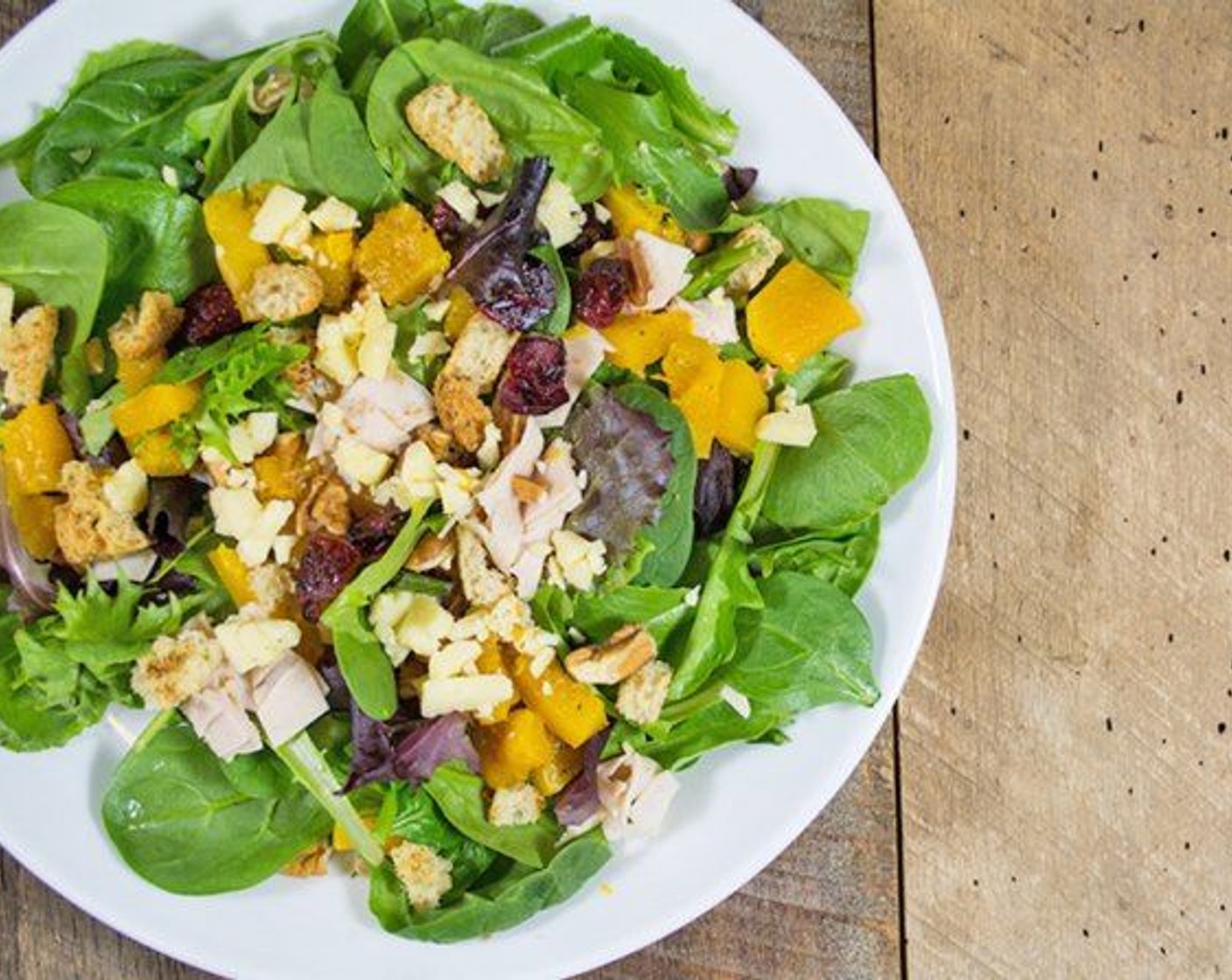 step 6 Dish out the greens between to plates or bowls, add butternut squash, Croutons (to taste), and dressing. Serve and enjoy!