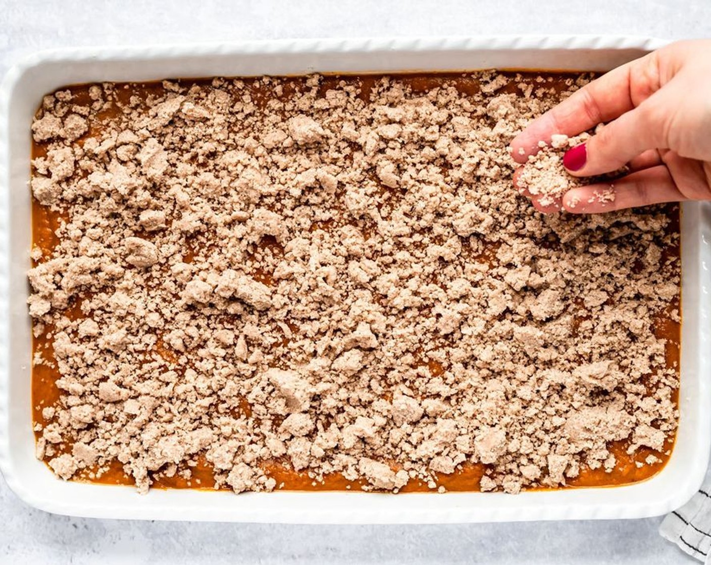 step 6 In a small mixing bowl, combine the 1 cup of reserved cake mix, Granulated Sugar (1/4 cup), Ground Cinnamon (1 tsp), and Unsalted Butter (1/4 cup). Sprinkle evenly over the filling.