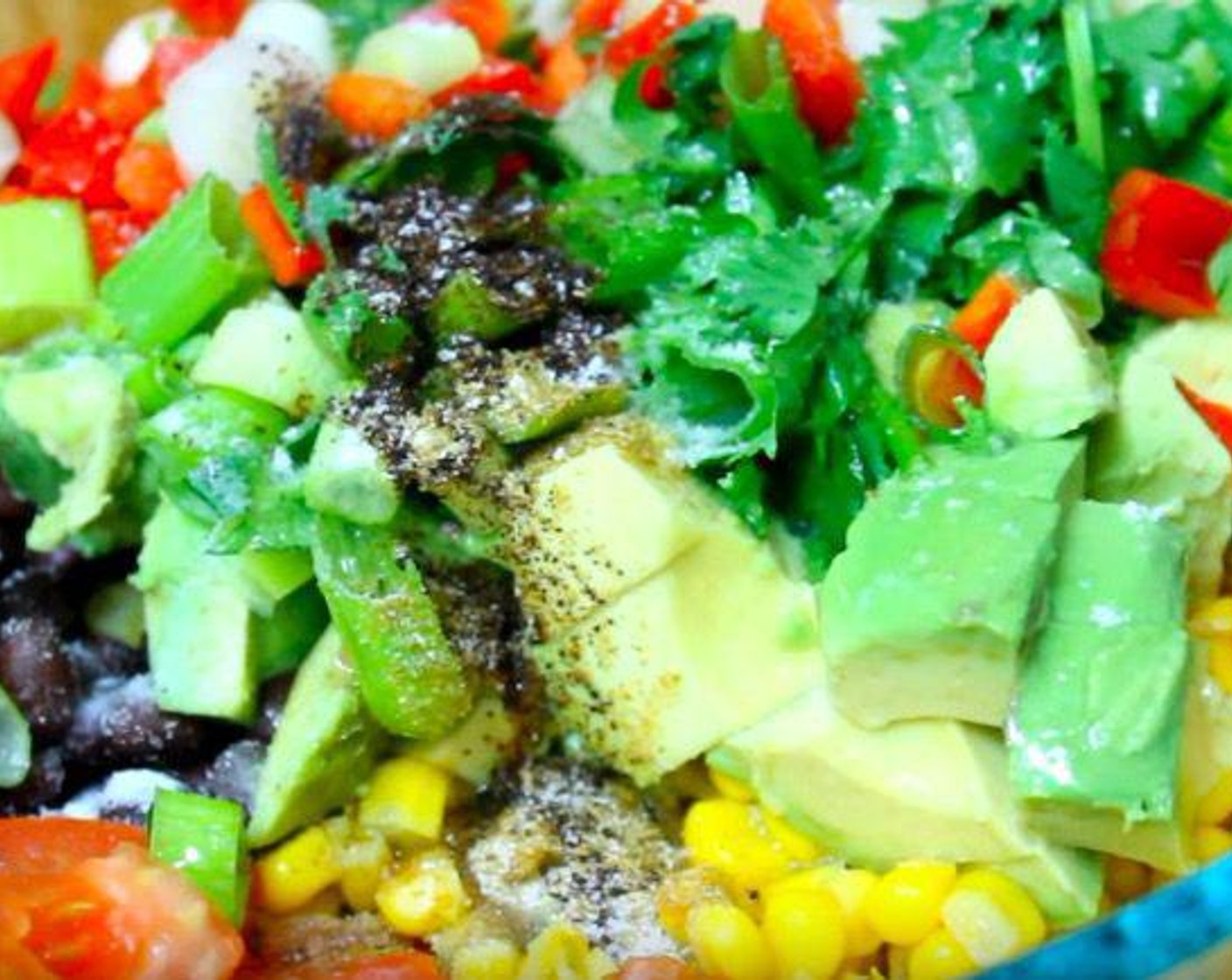 step 1 In a mixing bowl, add GOYA® Black Beans (2 1/3 cups), Corn Kernels (2 1/2 cups), Plum Tomato (1), Avocado (1), Fresh Cilantro (4 Tbsp), Scallion (1 bunch), Red Bell Pepper (1), Ground Cumin (1/4 tsp), Chili Powder (1/2 tsp), Extra-Virgin Olive Oil (2 Tbsp), Salt (to taste), and Ground Black Pepper (to taste). Squeeze Lime (1) over top. Mix together.