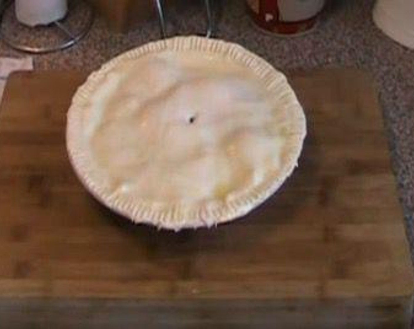 step 3 Place the other Puff Pastry (1 sheet) over top and press edges to seal. Trim off excess pastry from the sides. Using a fork, press around the edge of the pie. Using a knife, poke a small hole in the middle.
