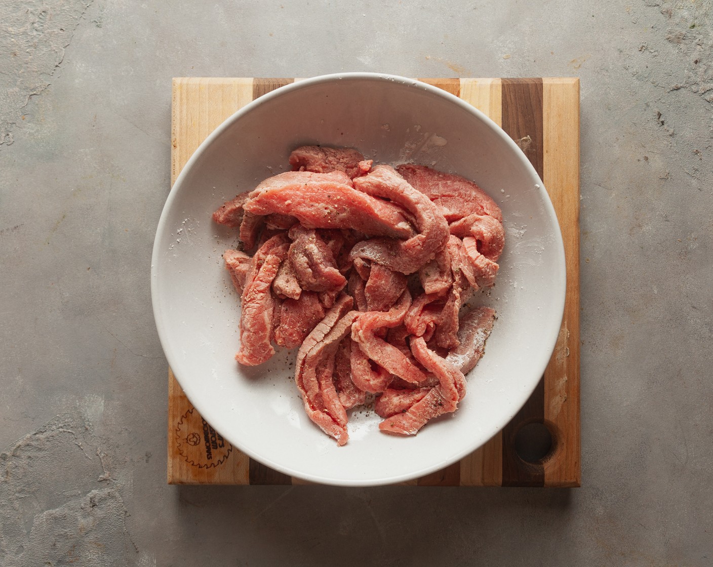 step 2 In a large bowl, combine the Beef Strips (1 lb), Corn Starch (3 Tbsp), and Ground Black Pepper (1/4 tsp). Mix to coat the beef evenly with starch.