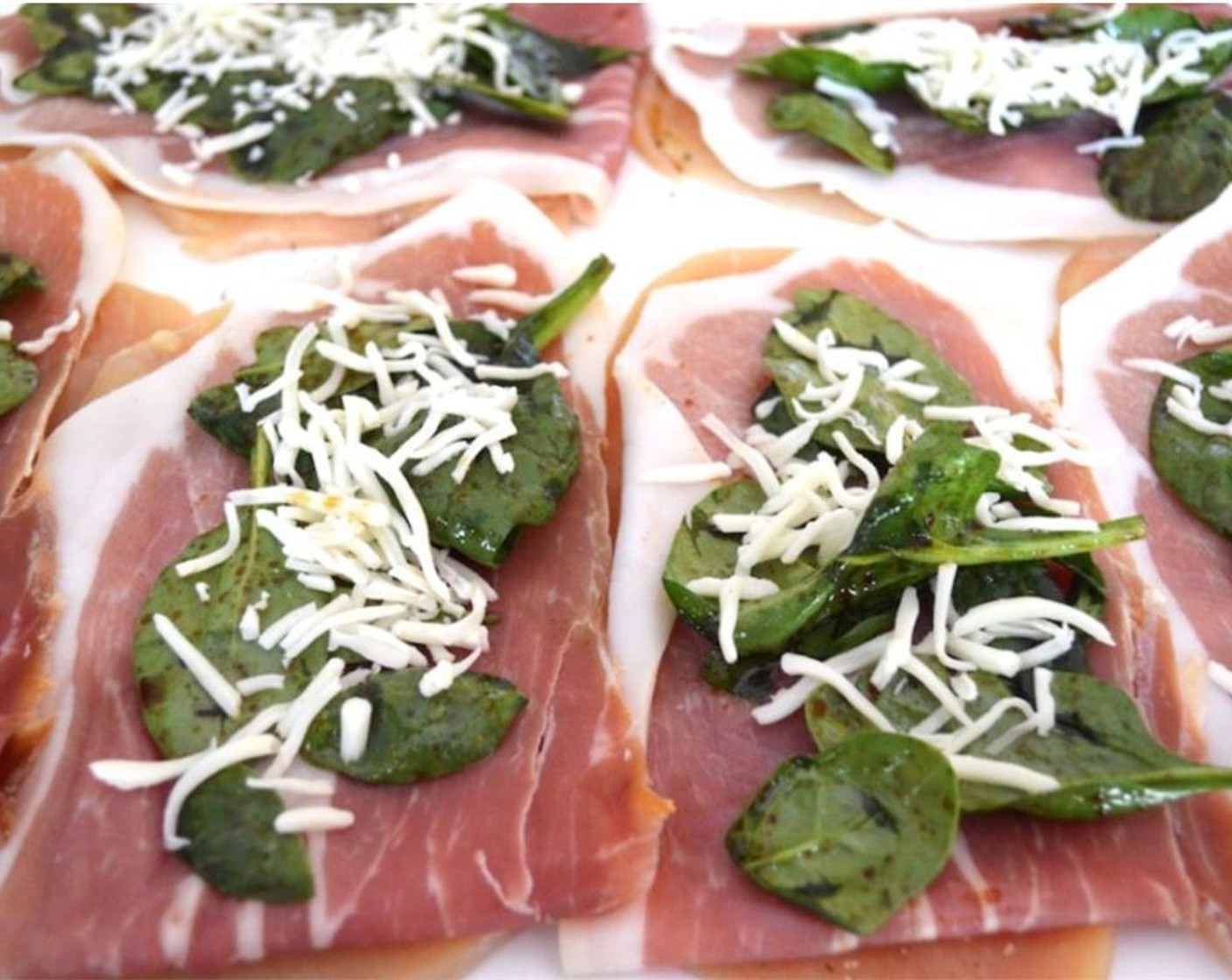 step 3 Lay a slice of Prosciutto (6) on top of each chicken breast, and evenly distribute the spinach on top of the prosciutto. Lastly, evenly distribute the Shredded Mozzarella Cheese (3/4 cup) on top of the spinach.