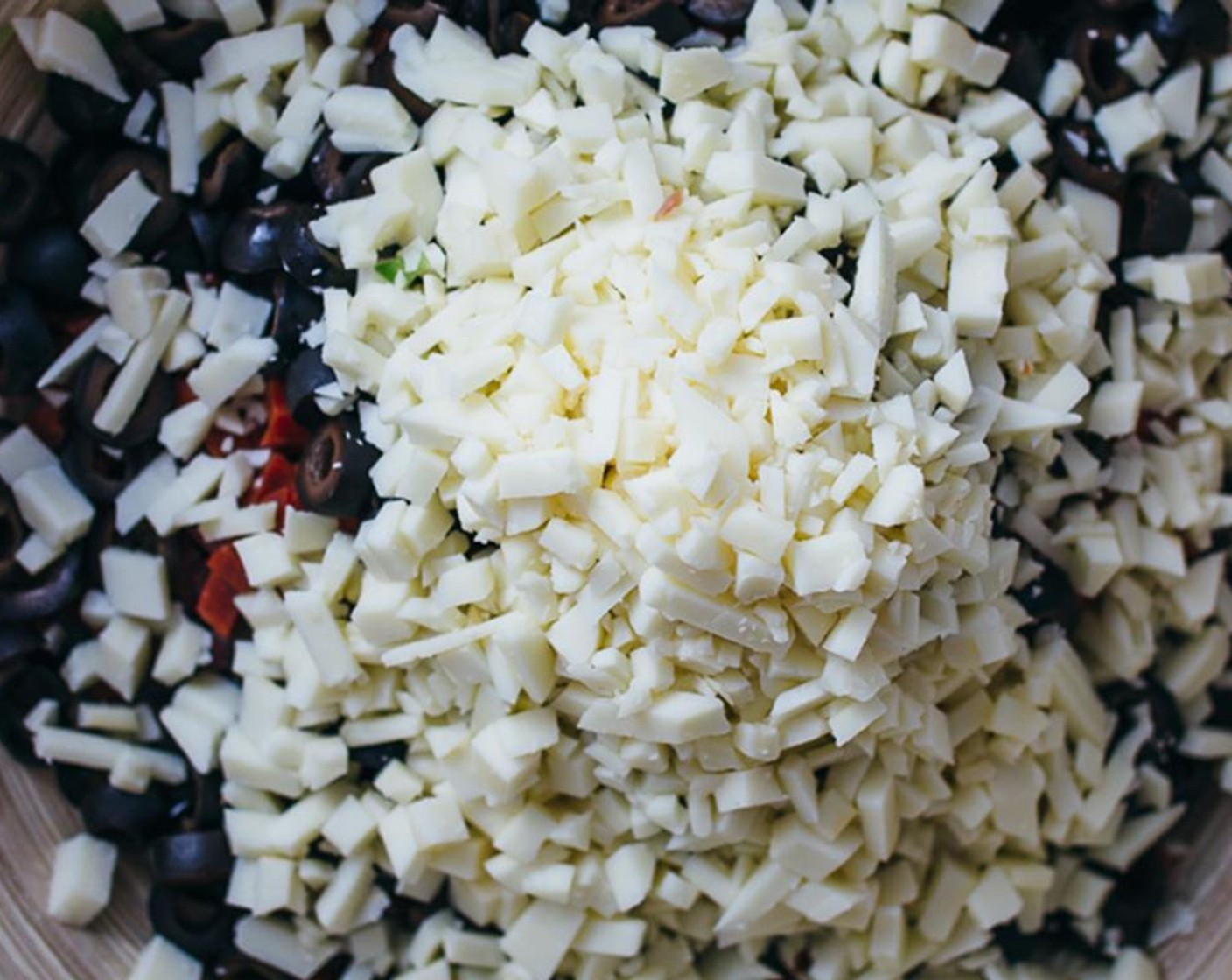 step 2 In a large mixing bowl, combine and mix the Red Bell Pepper (1), Green Bell Pepper (1), Genoa Salami (5 oz), Pepperoni Sausage (5 oz), Canned Sliced Black Olives (1 1/2 cups) and Asiago Cheese (2 cups).