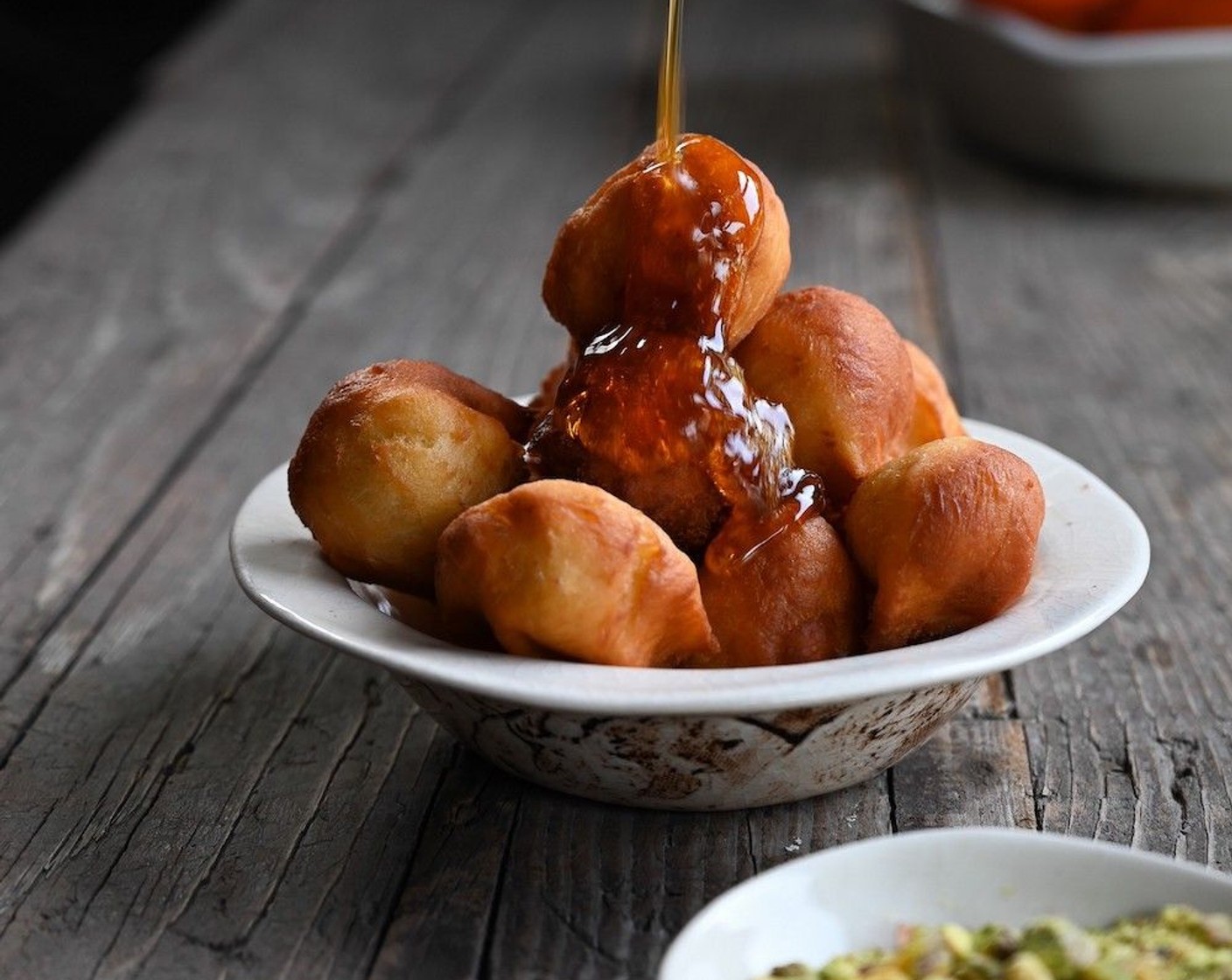 step 6 Dip each doughnut into the syrup and serve the loukoumades topped with Pistachios (to taste).