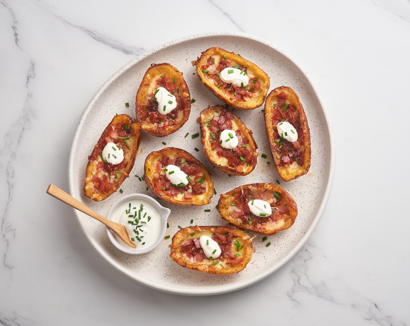step 10 Top each potato with a dollop of Sour Cream (1 cup) and sprinkle with Scallions (3 stalks). Enjoy it fresh out of the oven and serve along with the cocktails!