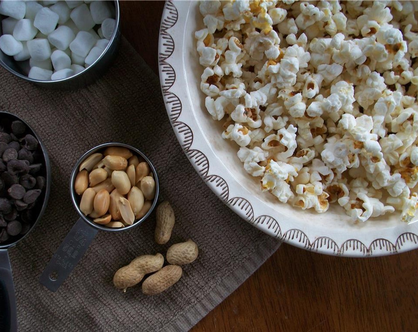 step 2 Pop the Popcorn Kernels (1/4 cup). Let it cool. Add chopped peanuts and Mini Marshmallows (1/2 cup). Set aside.