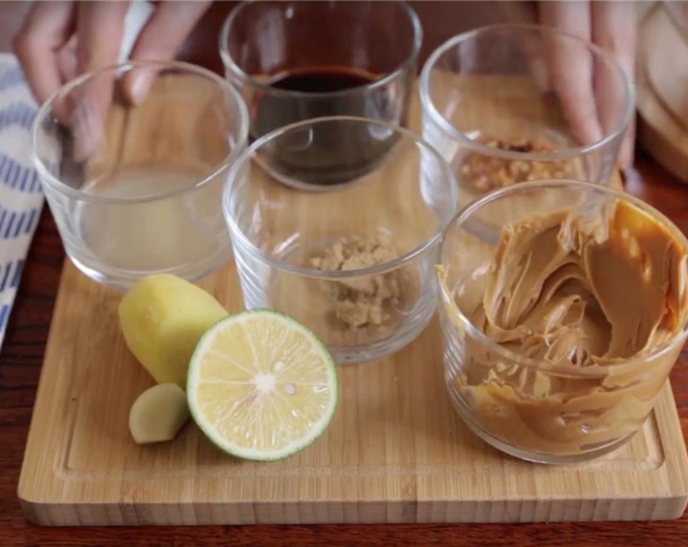 step 7 Once garlic clove and ginger are finely minced, add the Creamy Peanut Butter (1/2 cup), Reduced Sodium Soy Sauce (2 Tbsp), juice from Lime (1/2), Brown Sugar (1 tsp), and Crushed Red Pepper Flakes (1/2 tsp).