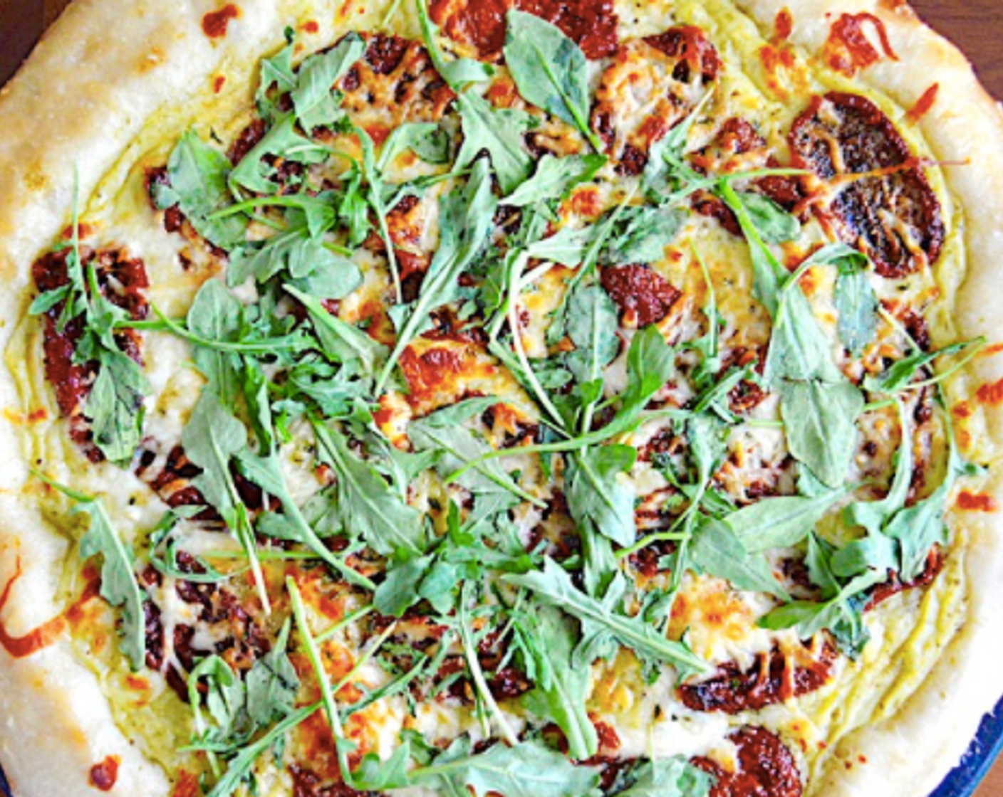 step 11 Take it out and evenly distribute the arugula on top. It will wilt right into the hot pizza. Use a sharp knife or pizza cutter to cut it into 8 equal pieces and serve it immediately! Enjoy!