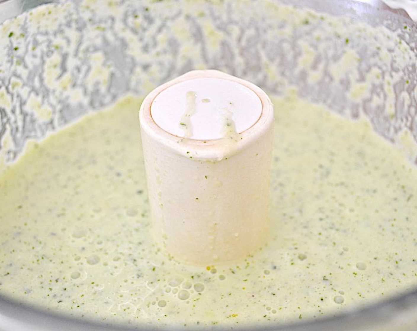 step 2 Set up a food processor and combine the remaining cucumber, Garlic (1 clove), Fresh Ginger (1 Tbsp), Scallion (1/3 cup), Fresh Mint (1/3 cup), Fresh Cilantro (1/3 cup), Salt (1 pinch), Freshly Ground Black Pepper (1 pinch), Greek Yogurt (1 1/2 cups) and Olive Oil (4 Tbsp) in it.