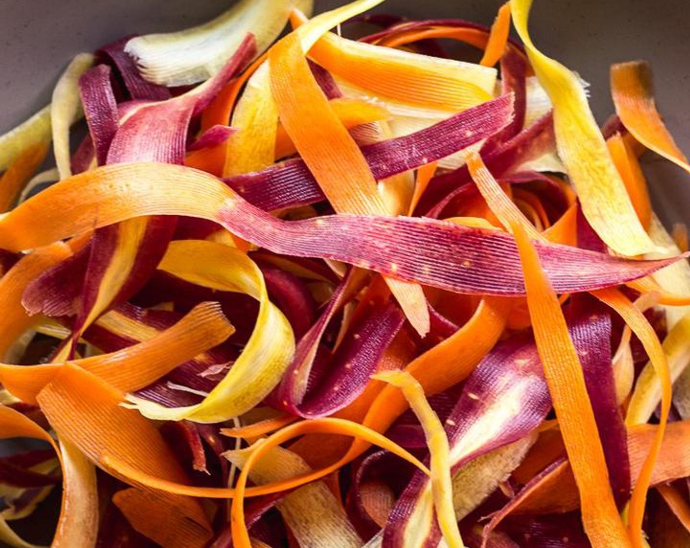 step 3 Finely chop a handful of carrot tops - resulting in about 1/4 cup. Place the carrot strips and tops in a large salad bowl.