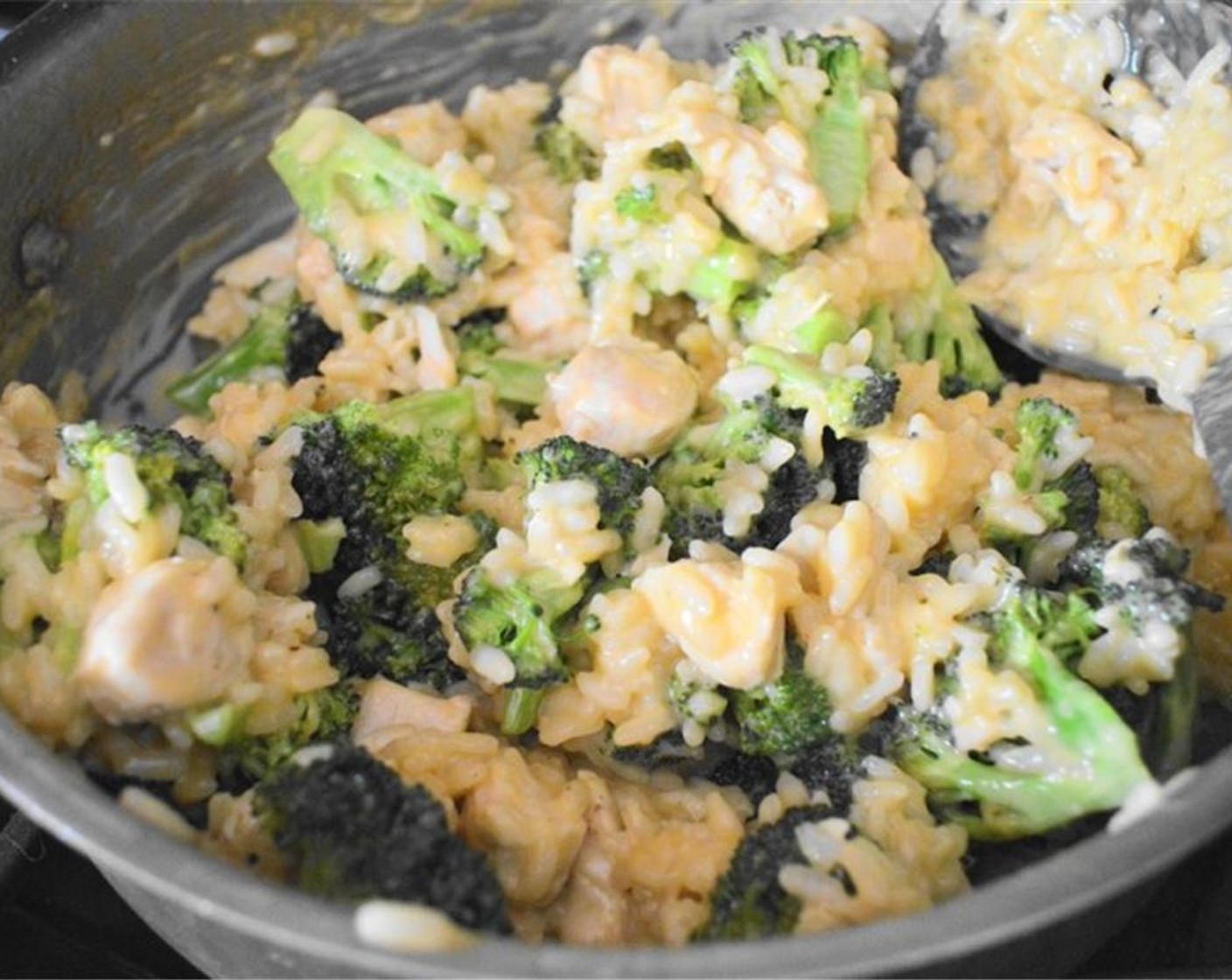 step 9 Once it is done, turn off the heat and stir in the Shredded Extra Sharp Cheddar Cheese (1 cup), chicken, and broccoli. Let it all meld together and warm through.