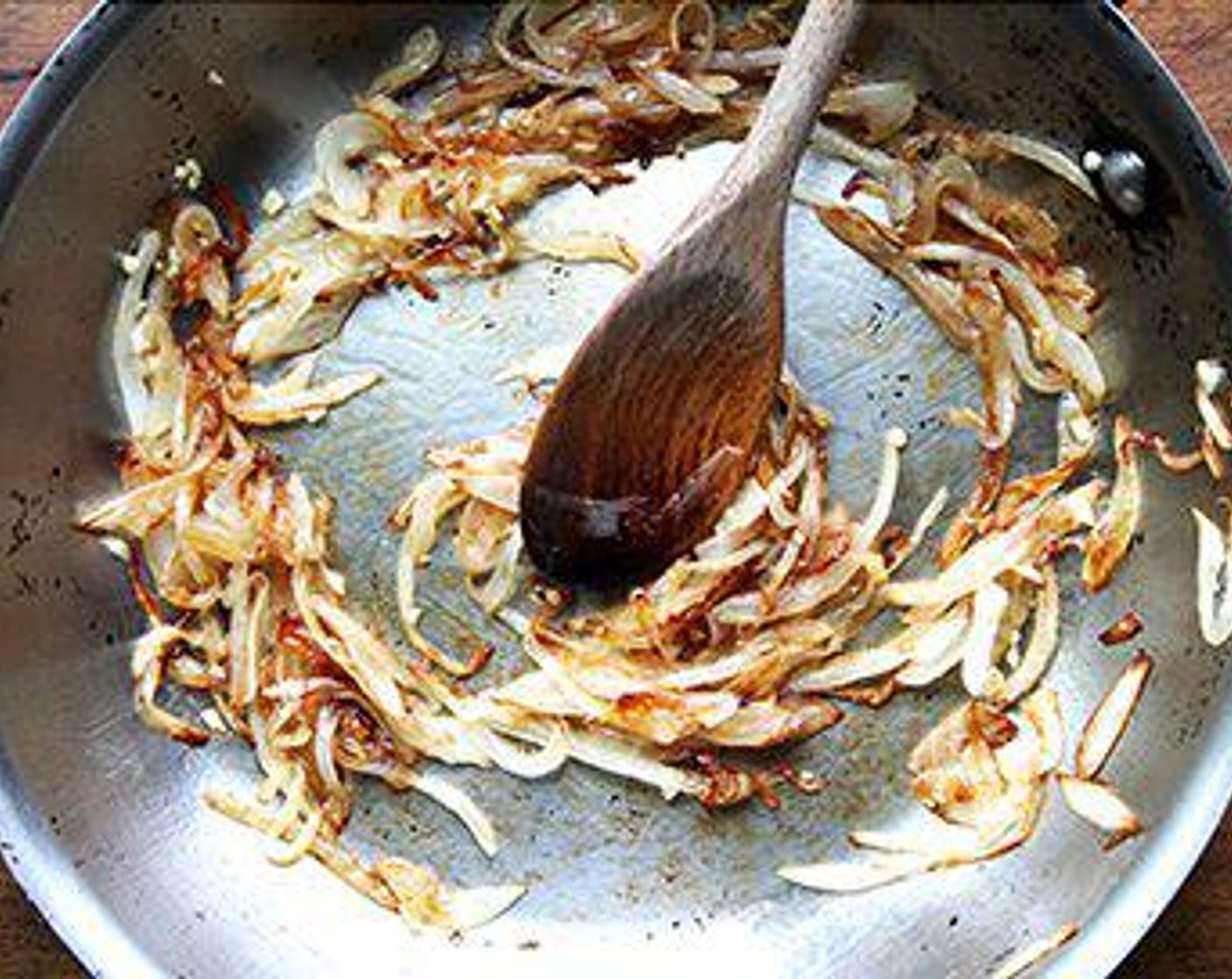 step 5 Meanwhile, heat a large sauté pan with the Olive Oil (as needed) and Onion (1) over medium heat. Season with Salt (to taste) and sauté the onions until just caramelized, about 20-25 minutes. Add the Garlic (2 cloves) and cook for a moment.