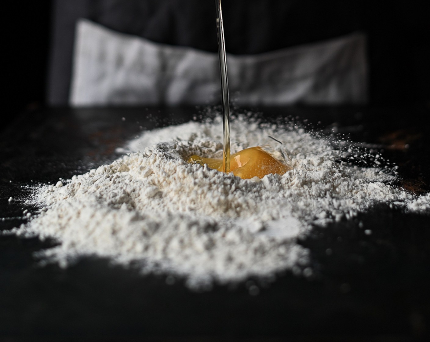 step 6 Pour in the Eggs (4) and, using a fork, work into the flour, forming a sticky dough.