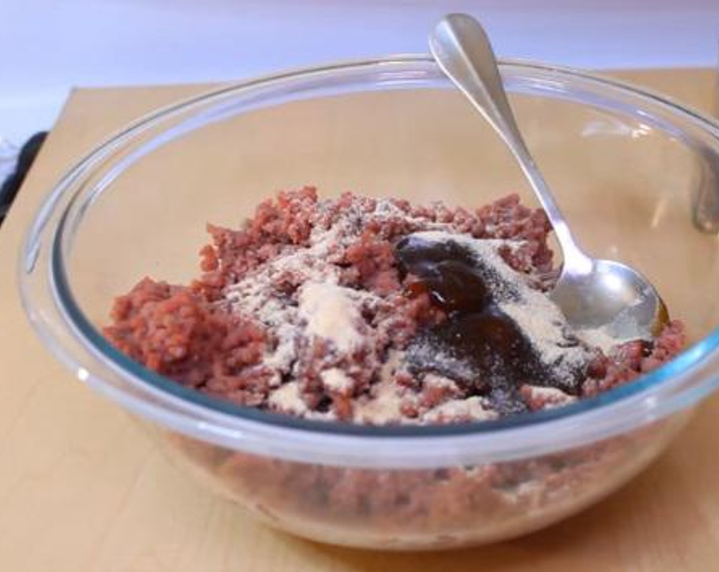 step 1 Using your hand, mix together the Ground Beef (8 oz), Barbecue Sauce (3 Tbsp), McCormick® Garlic Powder (1/2 Tbsp), Salt (to taste), and Ground Black Pepper (to taste).