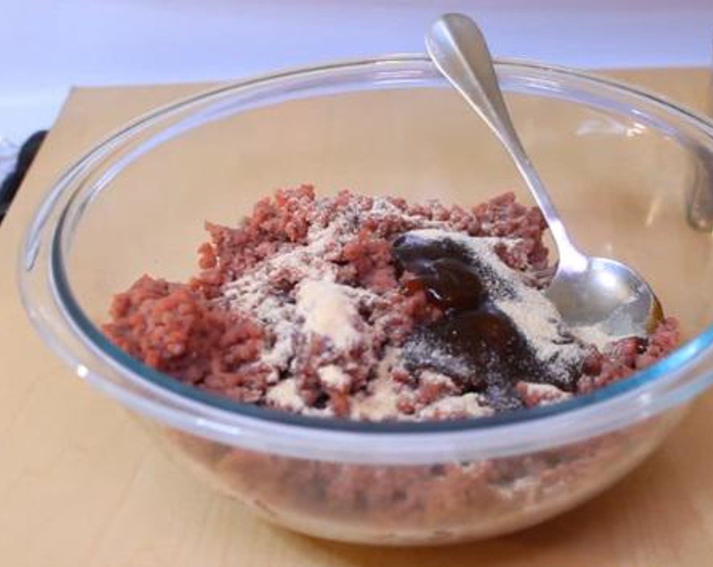 step 1 Using your hand, mix together the Ground Beef (8 oz), Barbecue Sauce (3 Tbsp), Simply Organic Garlic Powder (2 tsp), Salt (to taste), and Ground Black Pepper (to taste).