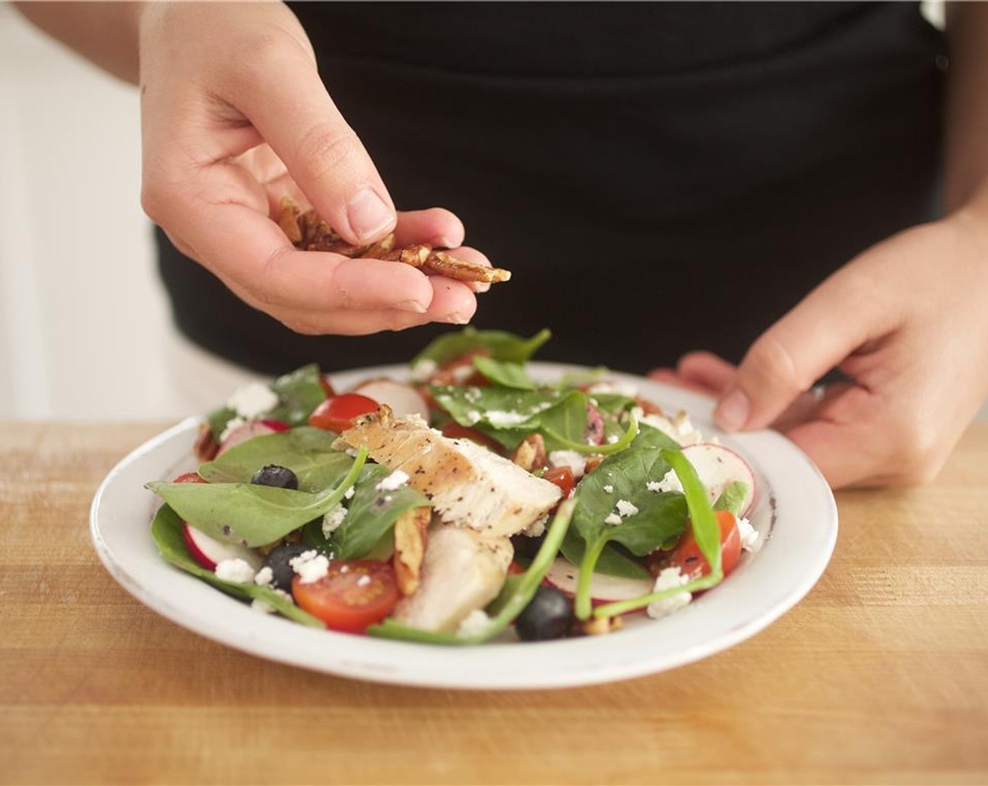 step 9 Divide the salad between two plates. Place half the chicken on each plate. Sprinkle with only half the Goat Cheese (4 Tbsp) and half the Roasted Pecan Halves (2 Tbsp).