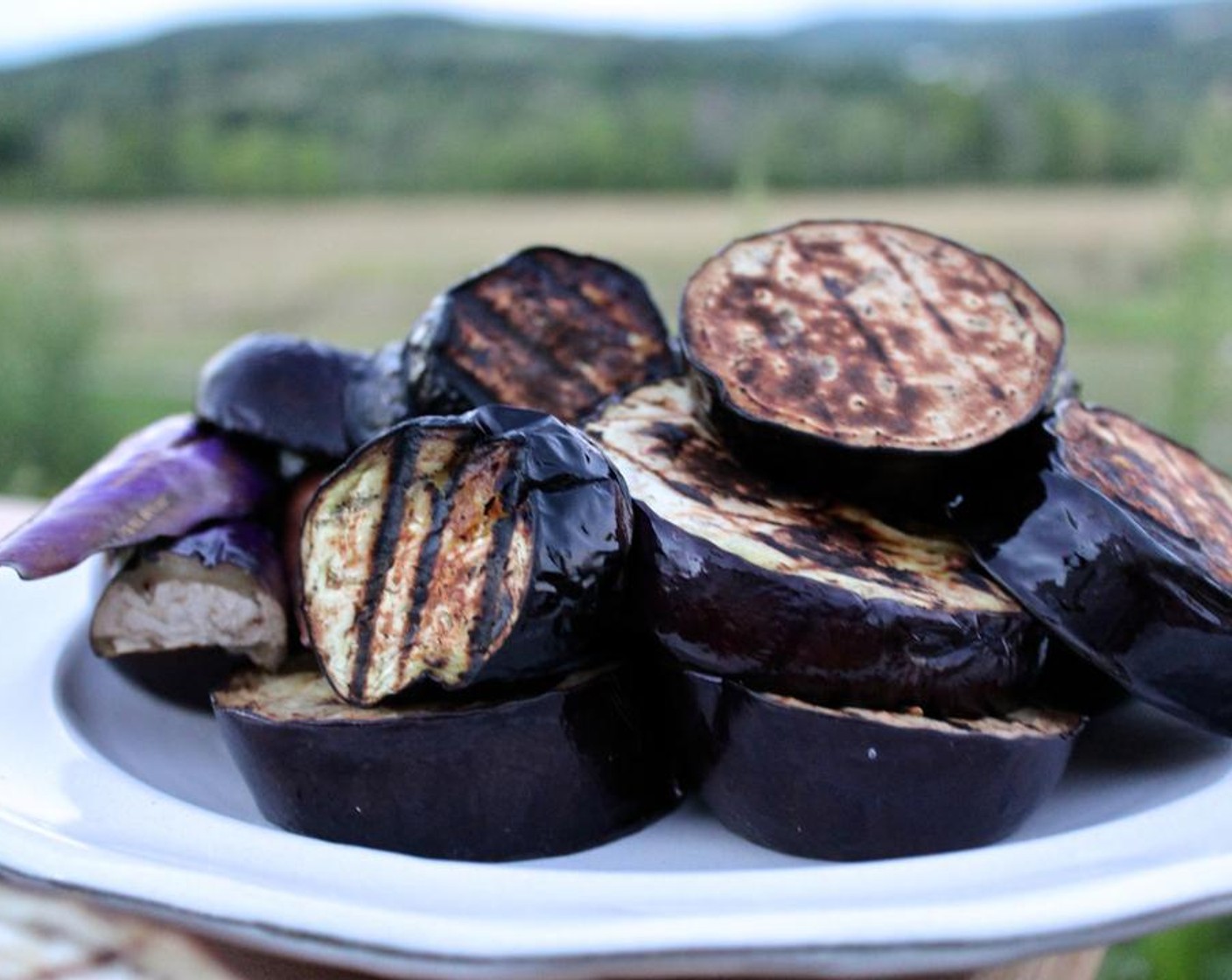 step 2 Cut the Eggplants (2) into slices. Brush the eggplant slices generously with Extra-Virgin Olive Oil (as needed), sprinkle with Kosher Salt (to taste) and Freshly Ground Black Pepper (to taste), and grill for 3-5 minutes on each side, until charred and cooked through.