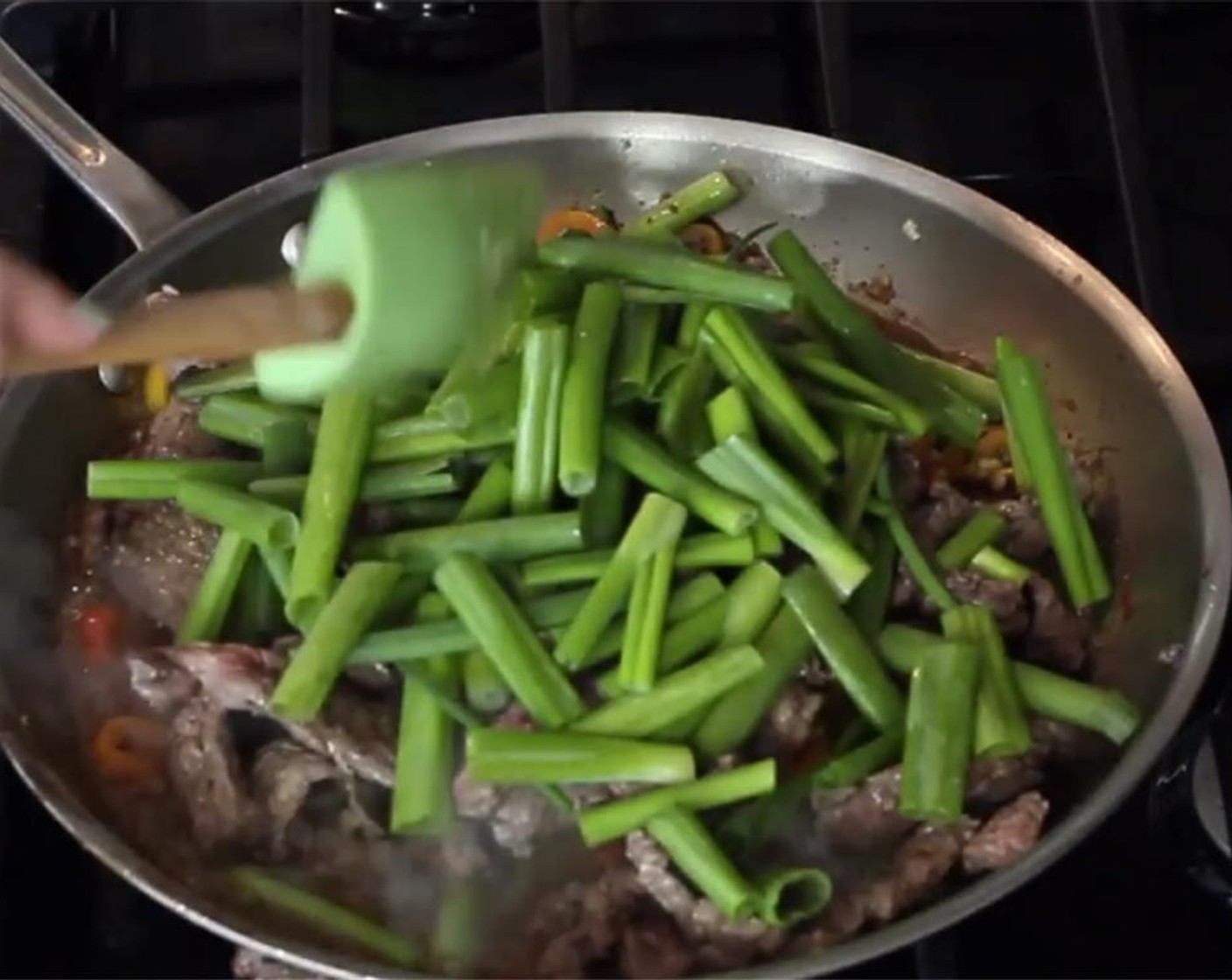 step 11 When the sauce comes to a bubble, add the steak back along with the scallions greens.