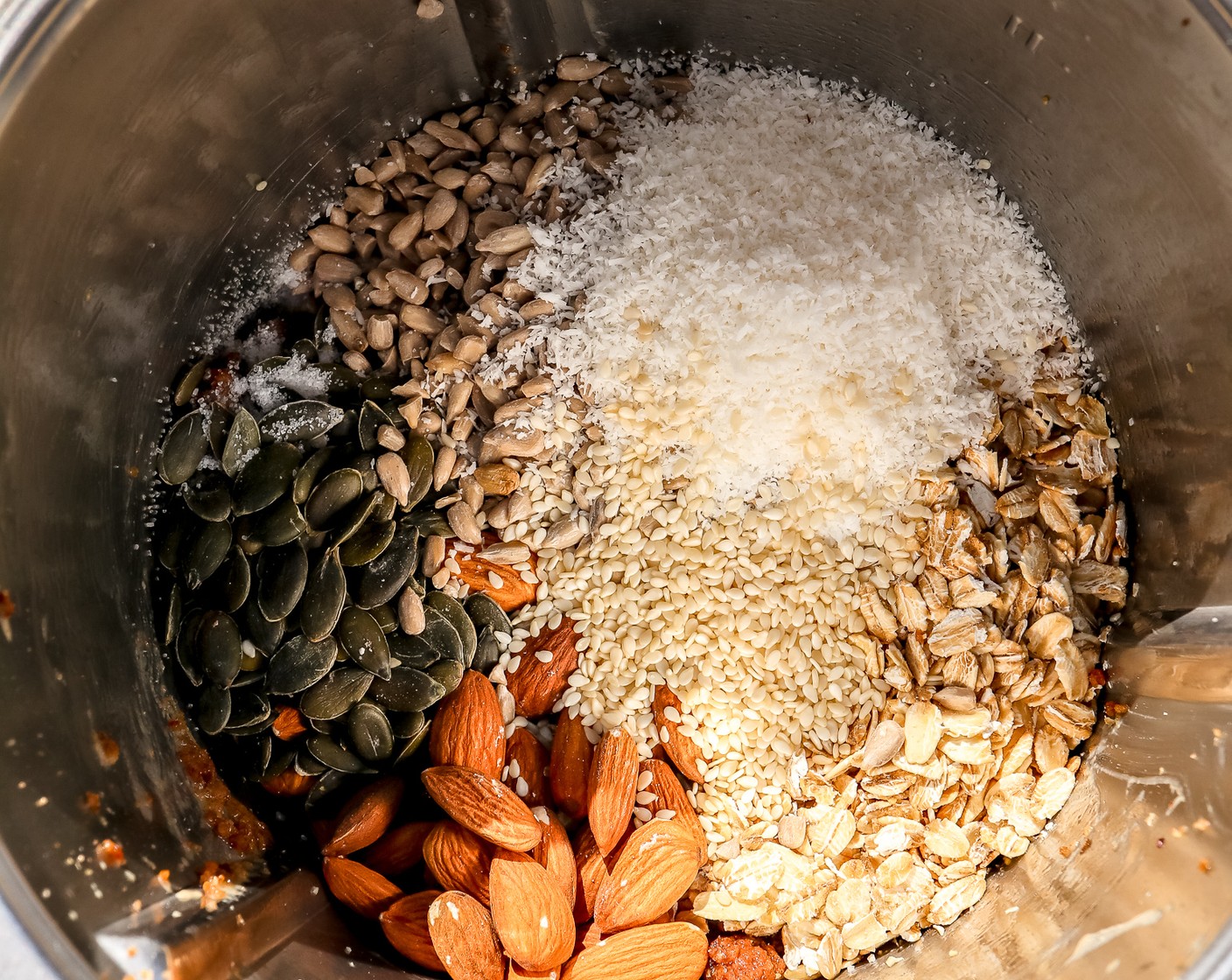 step 3 Add the Old Fashioned Rolled Oats (1/2 cup), Almonds (1/4 cup), Pepitas (2 Tbsp), Quinoa (3 Tbsp), Sunflower Seeds (2 Tbsp), Desiccated Coconut (2 Tbsp), and Salt (1/4 tsp).