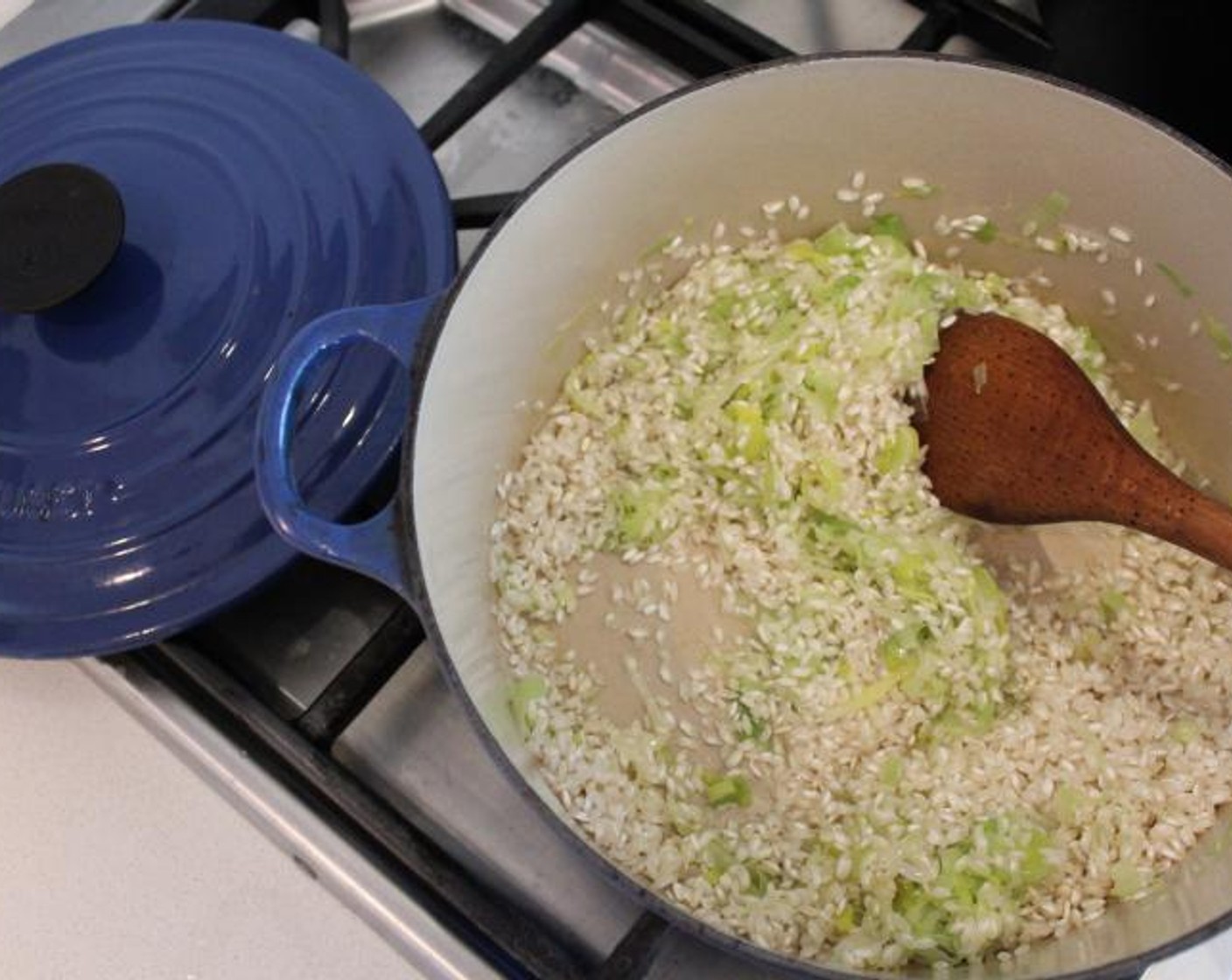 step 4 Add the Arborio Rice (1 1/2 cups) and stir for one more minute. Add the Dry White Wine (1/2 cup) and simmer over low heat, stirring constantly, until most of the liquid has evaporated.