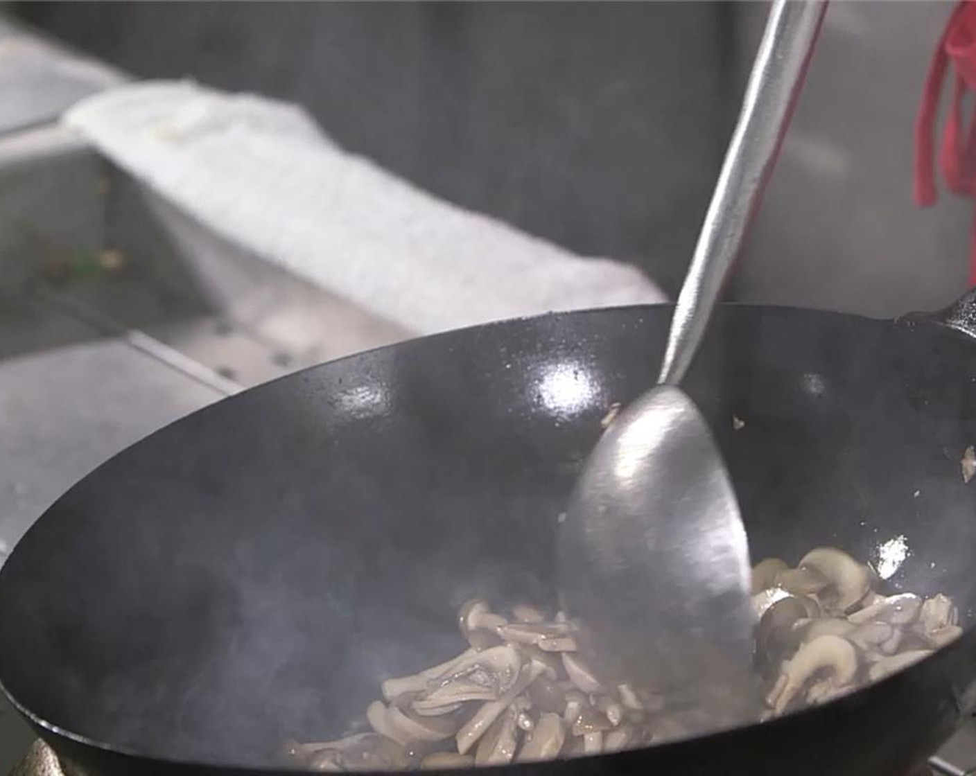 step 4 In a wok or large saute pan, heat up a generous amount of Vegetable Oil (as needed) over high heat. Add the mushrooms and stir fry for 2 minutes.