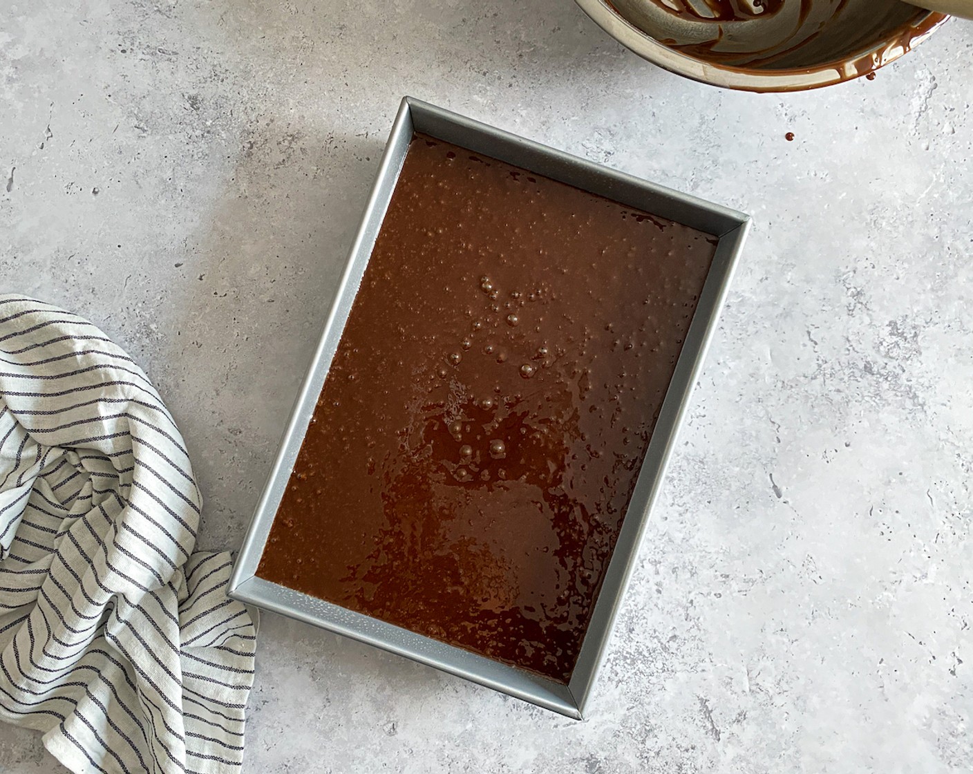 step 6 Pour batter into a lined baking tray or baking dish and bake for 35–40 minutes. Use a skewer to test if it comes out clean when pricking the center of the cake.