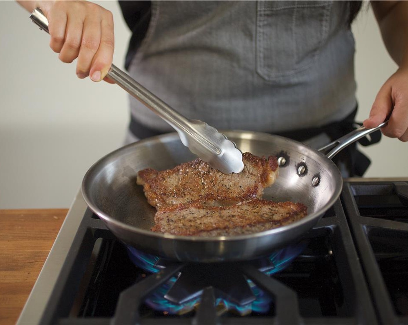 step 9 Drizzle both sides of the Boneless New York Strips (2) with 1 tablespoon olive oil, 1/4 teaspoon salt and 1/4 teaspoon of pepper. Heat a large saute pan over high heat. Once pan is hot, add steak and cook for 2 minutes on side only and turn over.