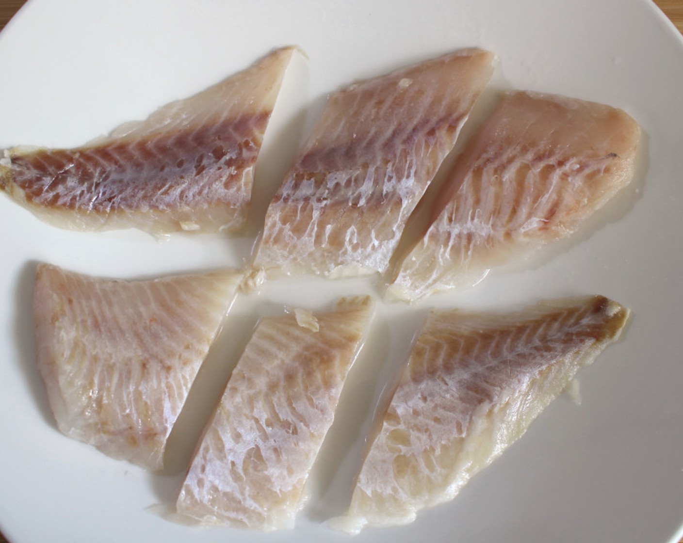 step 1 Cut the Ocean Perch Fillets (1.3 lb) into 3 to 4 oz pieces.