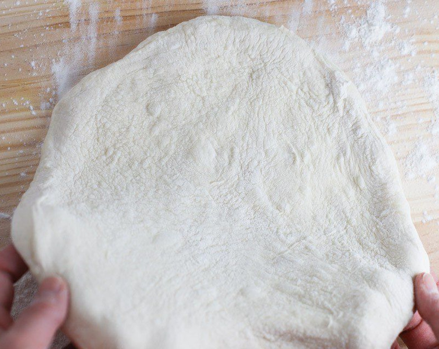 step 11 Form a dough ball into a disk on a well-floured surface. Stretch by hand pushing outward starting at the middle until round and about a 12-inch diameter pie.