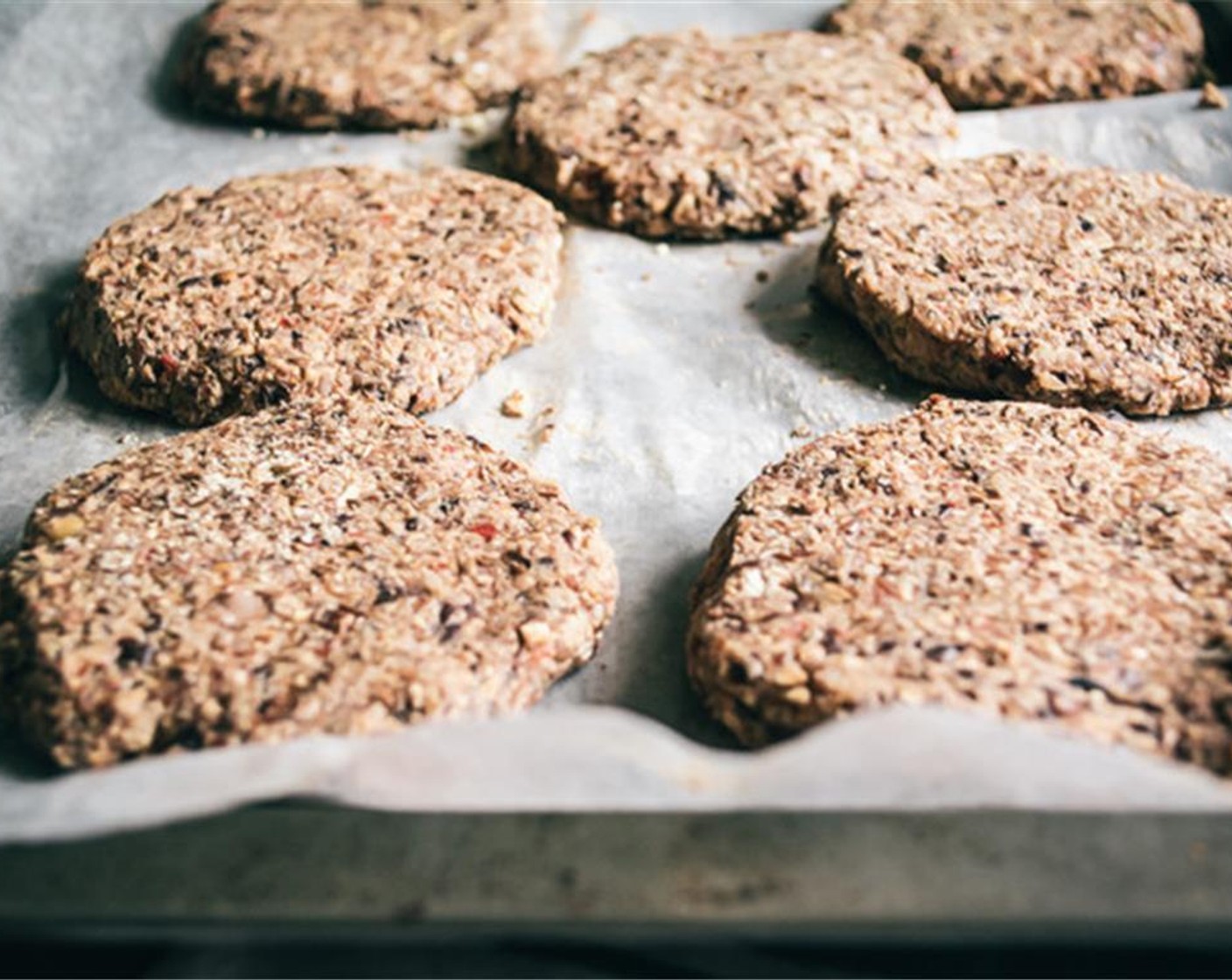 step 5 Line baking sheet with parchment paper, spray with Coconut Oil Cooking Spray (as needed) then divide black bean mixture into 7 to 10 balls (depending on your size preference), and flatten on parchment paper, repeat until you’ve done this with each patty.