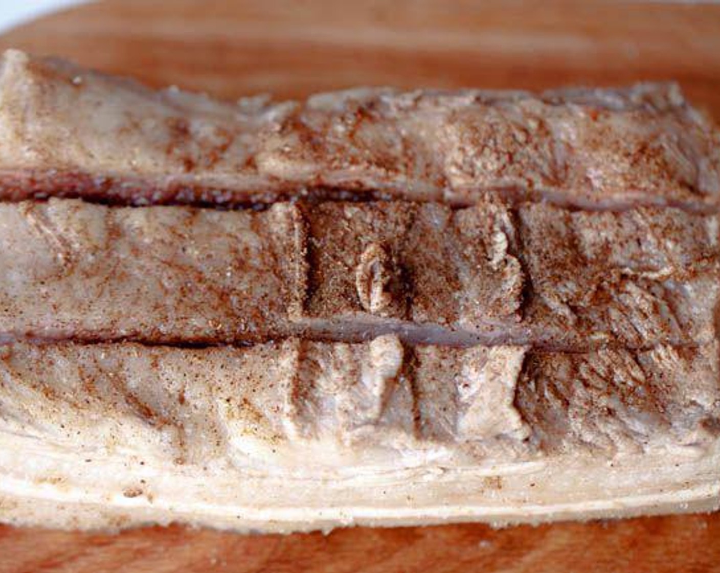 step 6 Cut two shallow lines on the pork (only the lean part, not deep to touch the fat) and then evenly sprinkle Salt (1 tsp), Chinese Five Spice Powder (2 tsp), Granulated Sugar (1/2 tsp), and Ground White Pepper (1 tsp).
