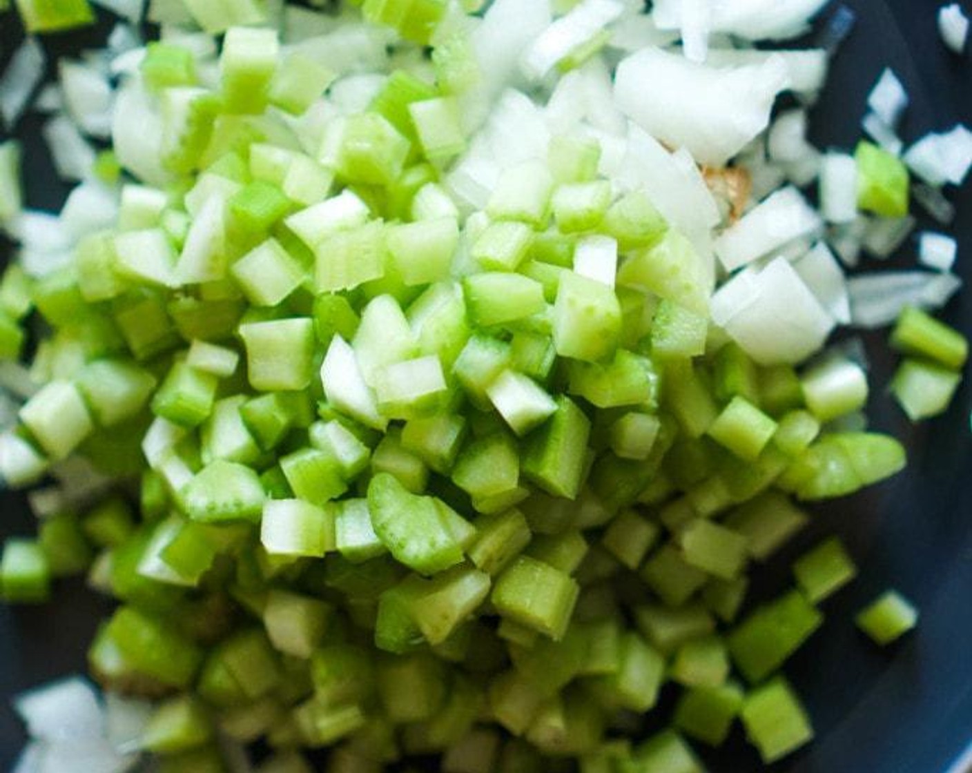 step 4 A few minutes before the sausage is done cooking, add the White Onion (1) and Celery (5 stalks) and cook 3-4 minutes until soft. Sprinkle with Salt (to taste) and Ground Black Pepper (to taste) for flavor. Taste and adjust as needed. Transfer to the bowl with the bread and toss.