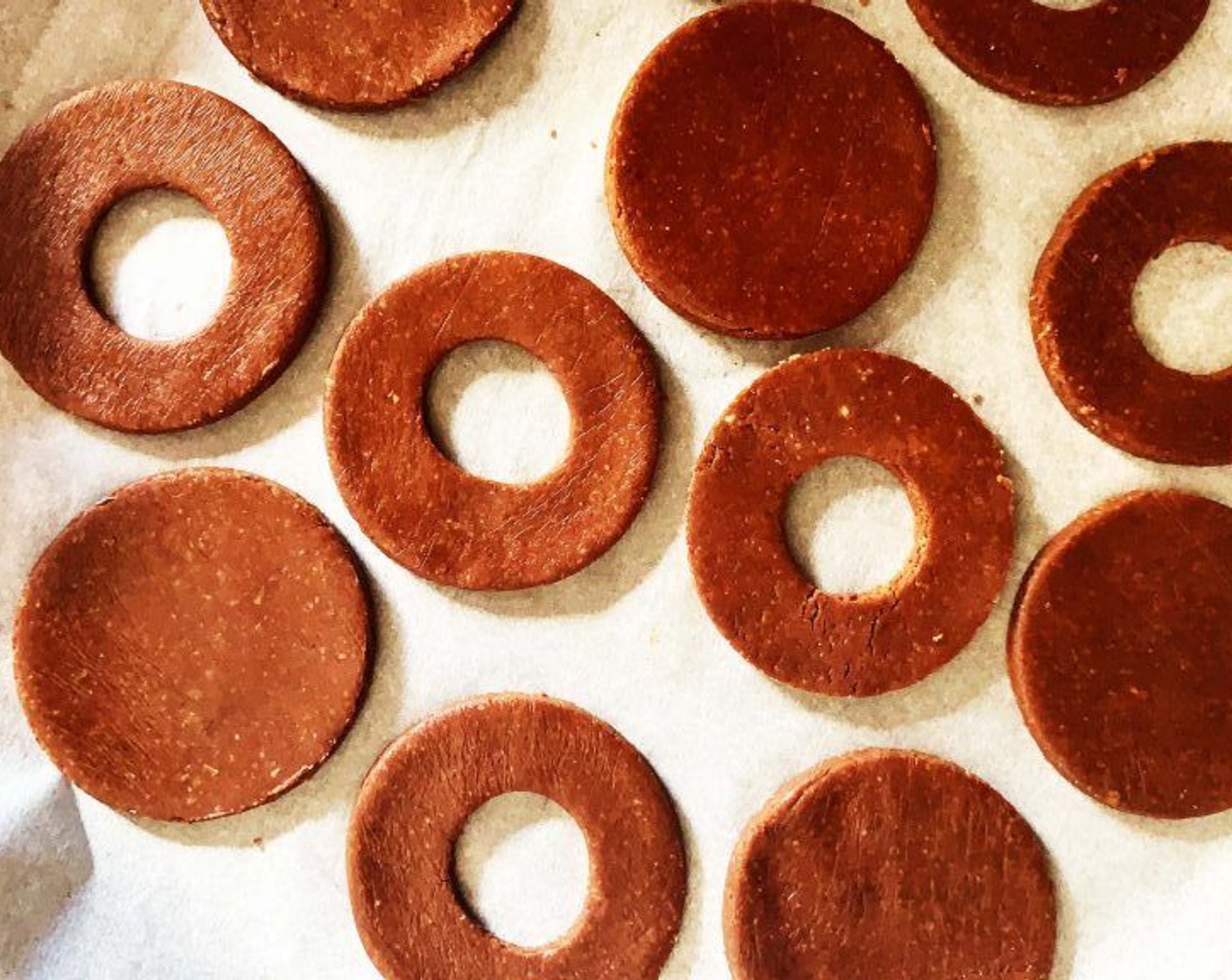 step 5 Cut out 12 pieces of dough with a cookie cutter, then use a smaller cutter to cut holes in the center of half of the circles.