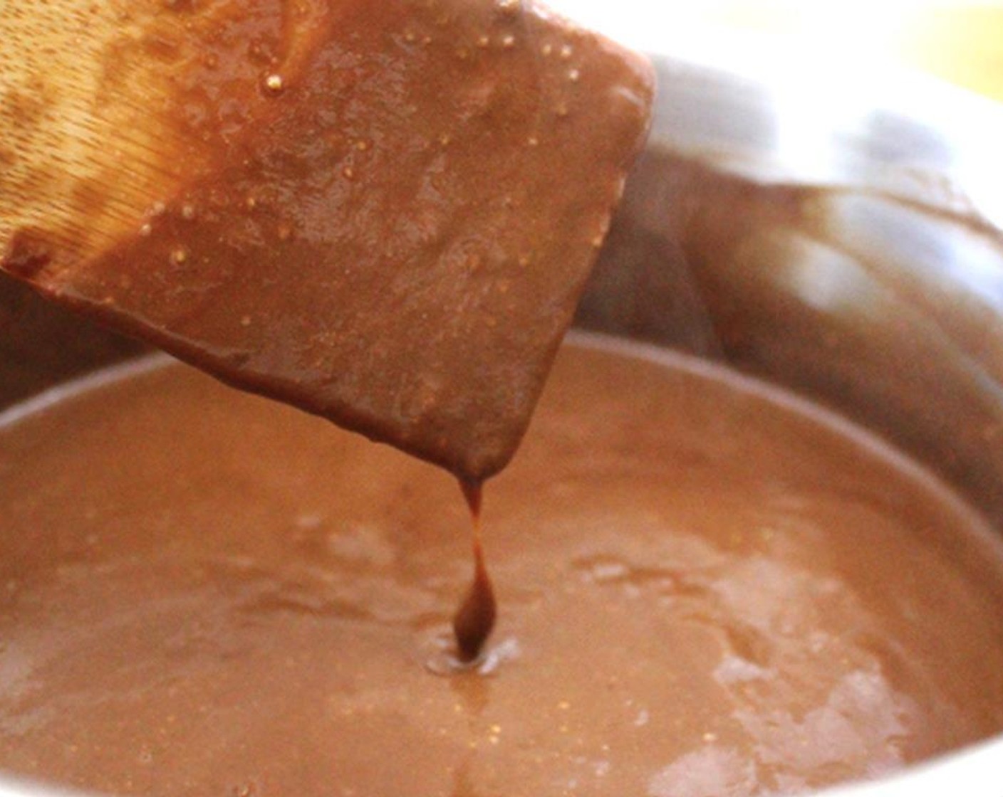 step 9 Let an ice cube melt in the bottom of a clean pot (this keeps the milk from scalding). Add the cornstarch mixture, Salt (1 pinch), Honey (3 Tbsp), and Milk (2 cups) and warm slowly, over medium heat, stirring occasionally.