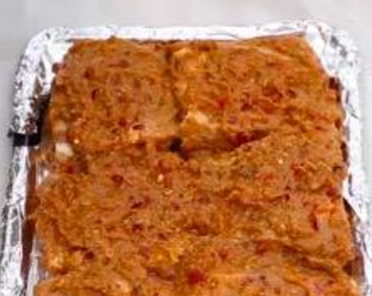 step 5 In a baking tray covered with aluminum foil, arrange the spare ribs meat side up. Sprinkle Crushed Red Pepper Flakes (1/4 tsp) on top.