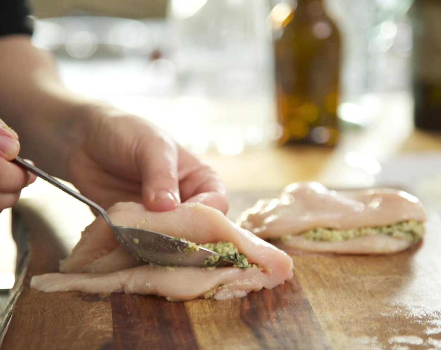 step 7 Spread the top half of the breast open but keeping the breast intact. Place half of the pesto in the pocket and spread the mixture evenly, leaving a 1/4 inch edge. Fold the top half over to cover. Repeat with the remaining pesto and chicken breast.