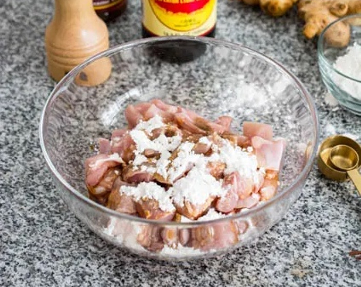 step 1 Marinate the Boneless, Skinless Chicken Thighs (4) in Sesame Oil (1 Tbsp), Light Soy Sauce (2 tsp), Corn Starch (1 Tbsp), and Ground Black Pepper (1 dash). Allow the chicken to marinate for 20-30 minutes at room temperature.